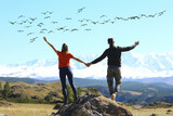 freedom concept, couple in love in a landscape with birds flying