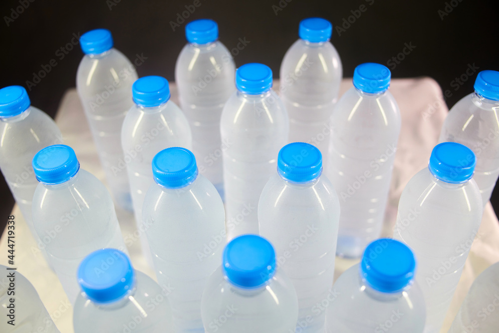closeup high angle view Lots of bottle of water isolated on black closeup high angle view Lots of bottle of water isolated on black