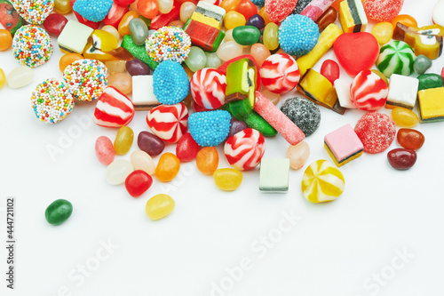 Multi-colored gummy candies on a white background. Festive backdrop.