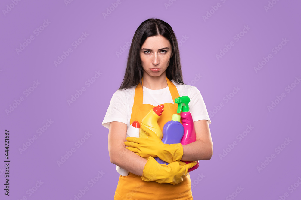 Sad housewife with heap of detergents Sad housewife with heap of detergents