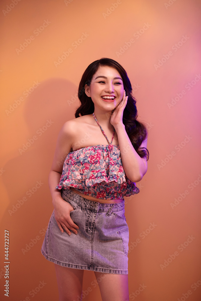Portrait of a beautiful young woman with bright glitter makeup posing in mixed color neon light Portrait of a beautiful young woman with bright glitter makeup posing in mixed color neon light