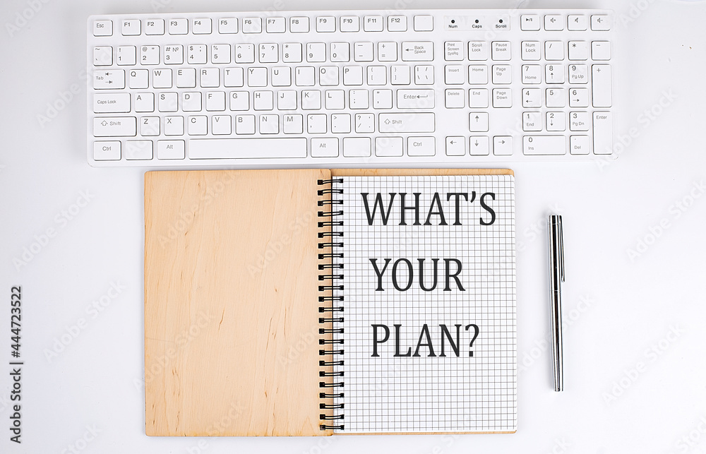 WHAT'S YOUR PLAN text on the notebook with keyboard on white background WHAT'S YOUR PLAN text on the notebook with keyboard on white background