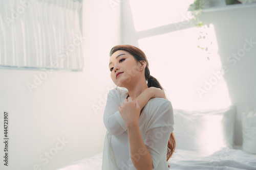 Close up shot of smiling woman in bed room