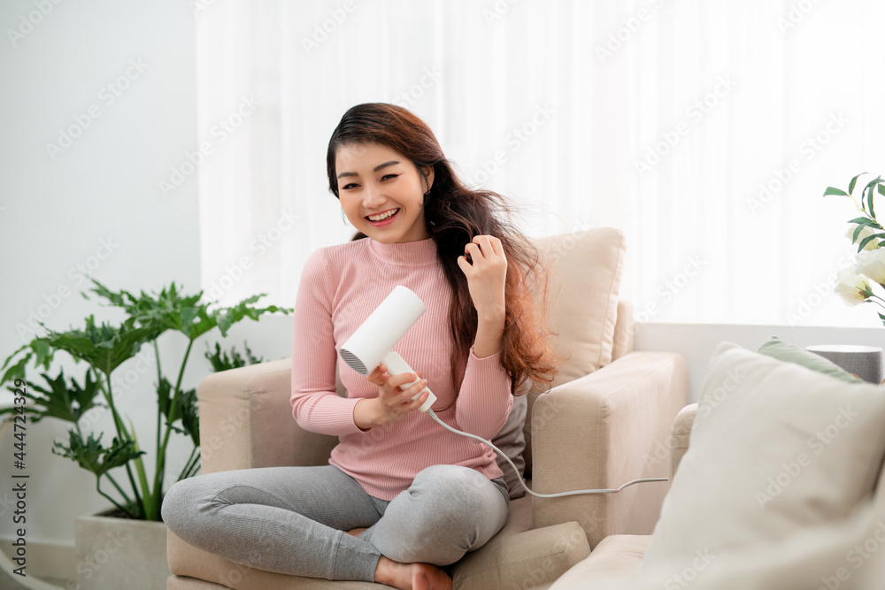 Portrait of beautiful woman, she holding hair dryer