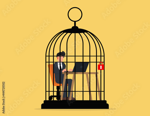 Stress at work concept. business man working at desk trapped inside birdcage
