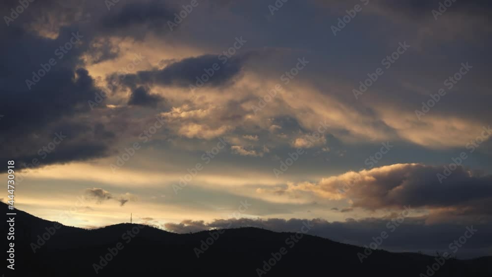 timelapse of golden sunset turning into twilight and clouds rolling over the mountains and thick vegetation shot in Tasmania, Australia timelapse of golden sunset turning into twilight and clouds rolling over the mountains and thick vegetation shot in Tasmania, Australia