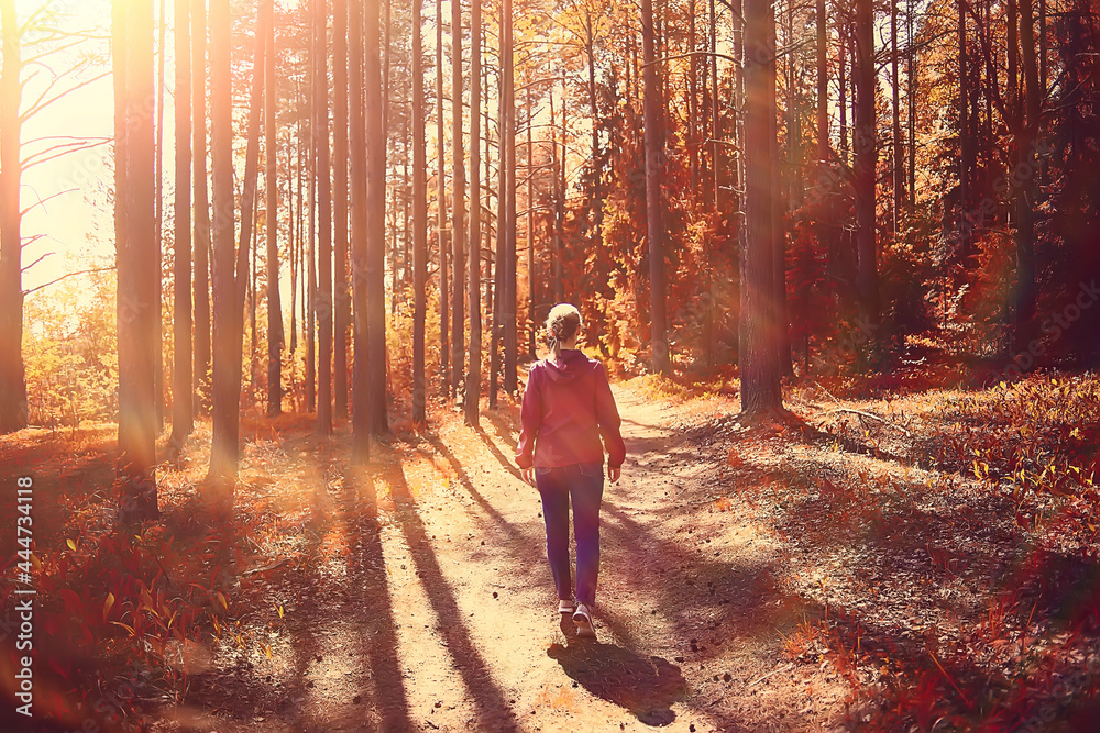 Fototapeta premium female sports style autumn forest, fitness tourism in a yellow park leaf fall sun