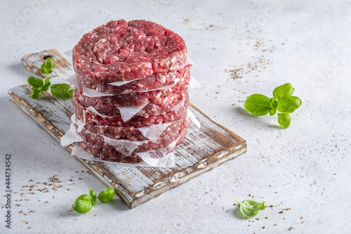 Obraz na plátně Stack of fresh raw beef burger patty