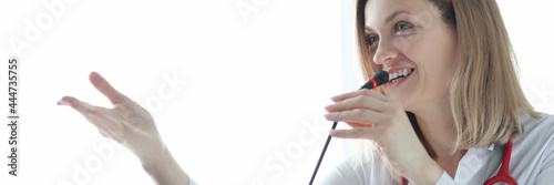 Woman doctor speaking into microphone at conference