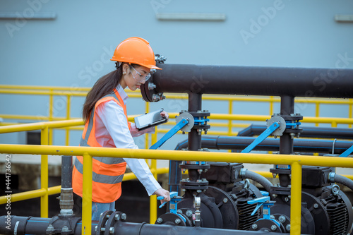 Worker under checking the waste water treatment pond industry large to control water support industry.