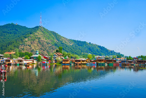 A variety of colorful boathouses. Beautiful lake and mountain views. View of Dal Lake in Srinagar, Kashmir State, India. June 2018 photo