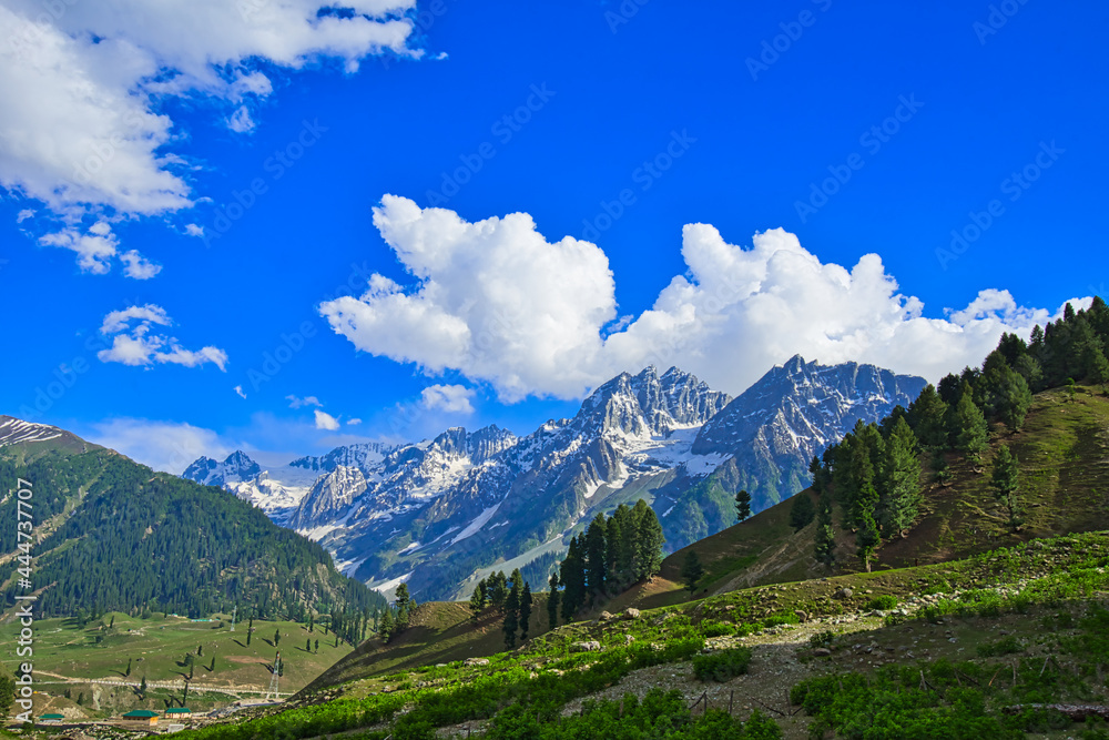Beautiful mountain scenery. Blue sky, white clouds, white snow. In-depth trip on the Sonamarg Hill Trek in Jammu and Kashmir, India, June 2018