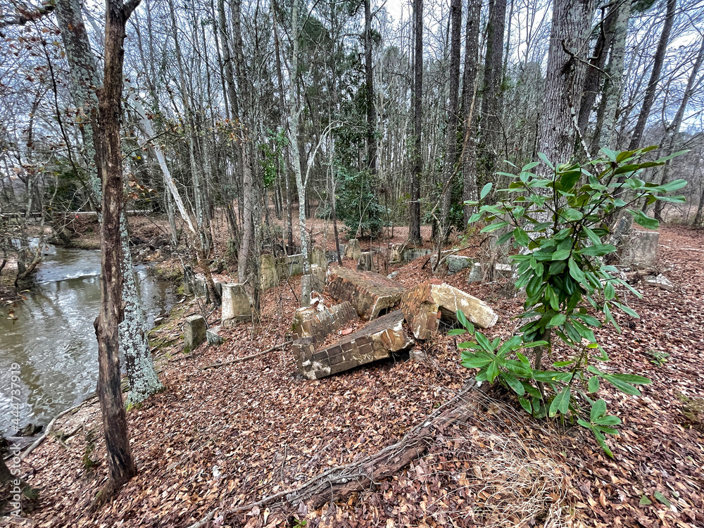 Brick ruins and river with fall foliage in a forest Brick ruins and river with fall foliage in a forest