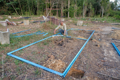 Gardener making nurserie from the c channel steel in the orchard. photo