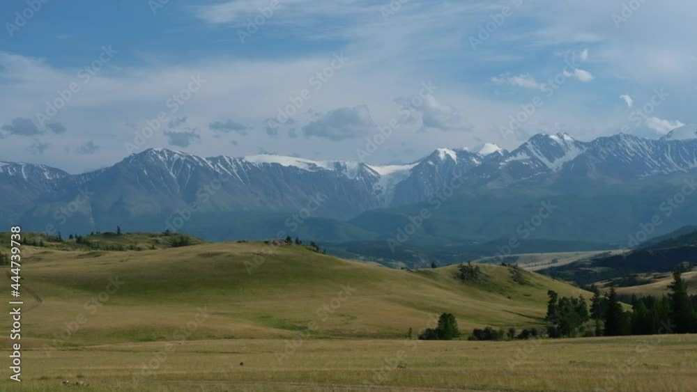 Beautiful panoramic view of hills and snowy peaks, sunset, slow motion