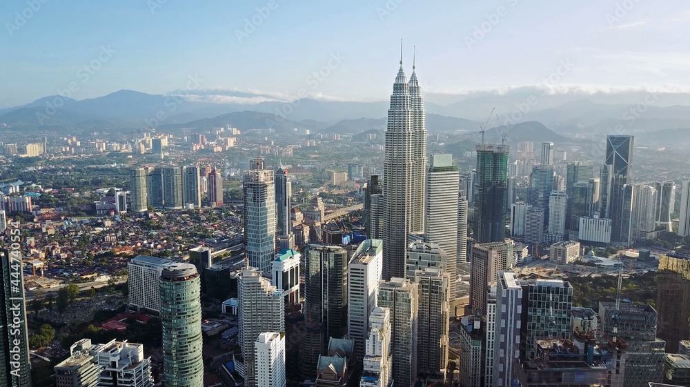 Aerial view of Kuala Lumpur cityscape. Photo from a drone of Asian skyscrapers. All logos are blurred.