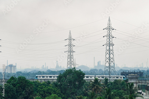 A wide shot of kochi metro moving through the track on a foggy morning pic was taken on 11 April 2021 at kochi India photo