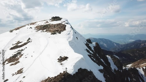 Views from Dumbier Mountain in Low Tatras mountains. Late spring, snow-capped mountains. Tourism and hiking NAPANT National Park travel destination. Aerial footage. photo