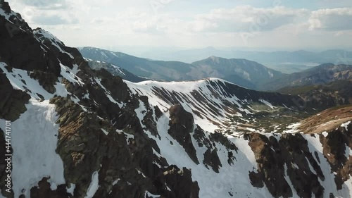 Views from Dumbier Mountain in Low Tatras mountains. Late spring, snow-capped mountains. Tourism and hiking NAPANT National Park travel destination. Aerial footage. photo