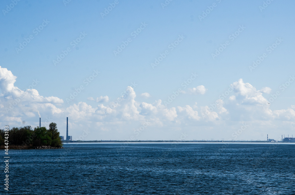reservoir, blue sea and blue sky with white clouds