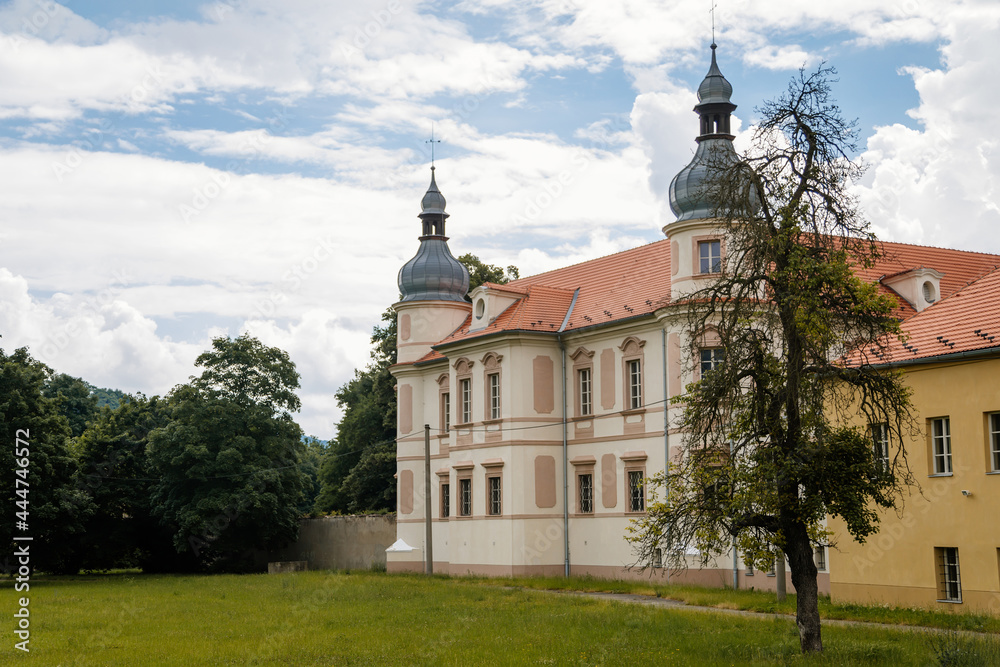 Krasne Brezno, Bohemia, Czech Republic, 26 June 2021:  Baroque castle with towers and green lawn, National cultural monument family chateau in summer sunny day