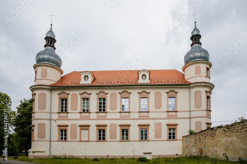 Krasne Brezno, Bohemia, Czech Republic, 26 June 2021: Baroque castle with towers and green lawn, National cultural monument family chateau in summer sunny day
