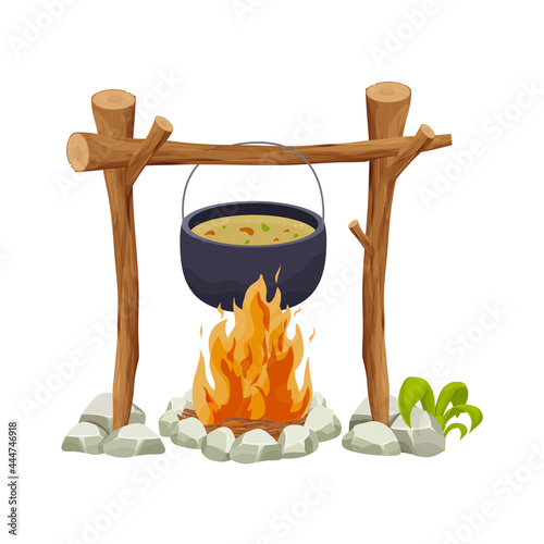 Black camping pot over a campfire in cartoon style isolated on white background. Wooden sticks, fire with stones, decorated with grass. Picnic cooking, travel preparation.