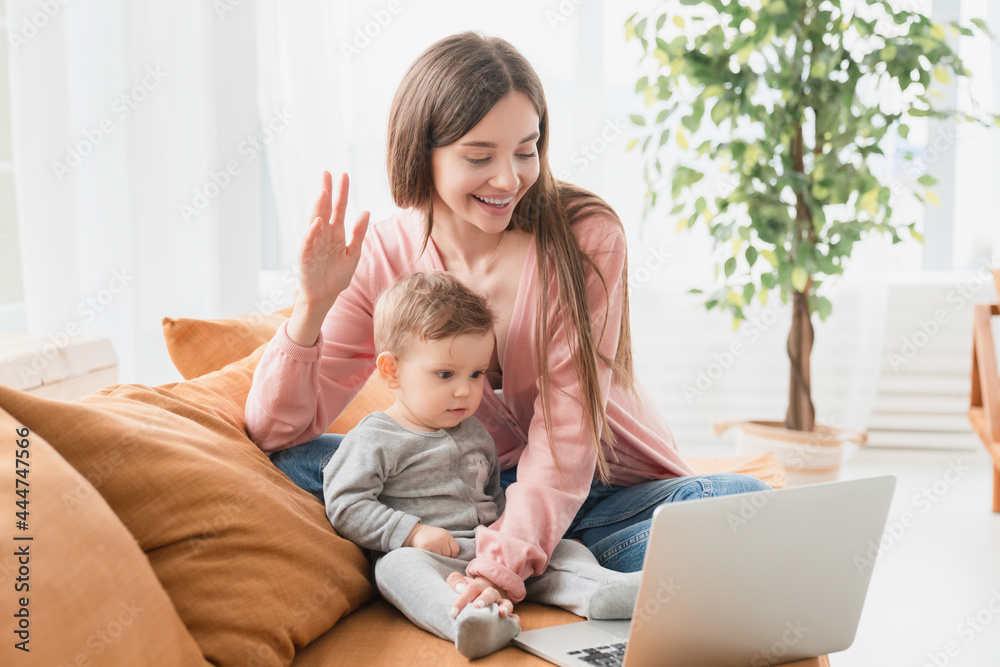Happy young mother with toddler infant newborn baby having video call online conference conversation with relatives doctor pediatrician, having consultation remotely, communicating with friends Happy young mother with toddler infant newborn baby having video call online conference conversation with relatives doctor pediatrician, having consultation remotely, communicating with friends
