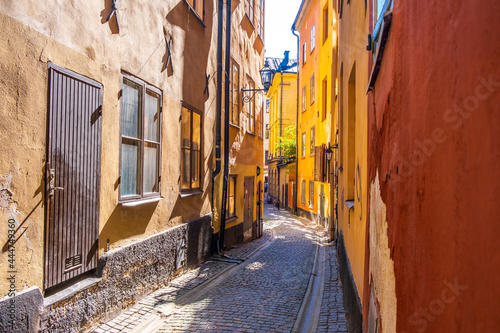 Colourful historic buildings and houses in Gamla Stan. Romantic medieval city centre alleys. Popular tourist destination in Scandinavia on a sunny day. © Zuzana