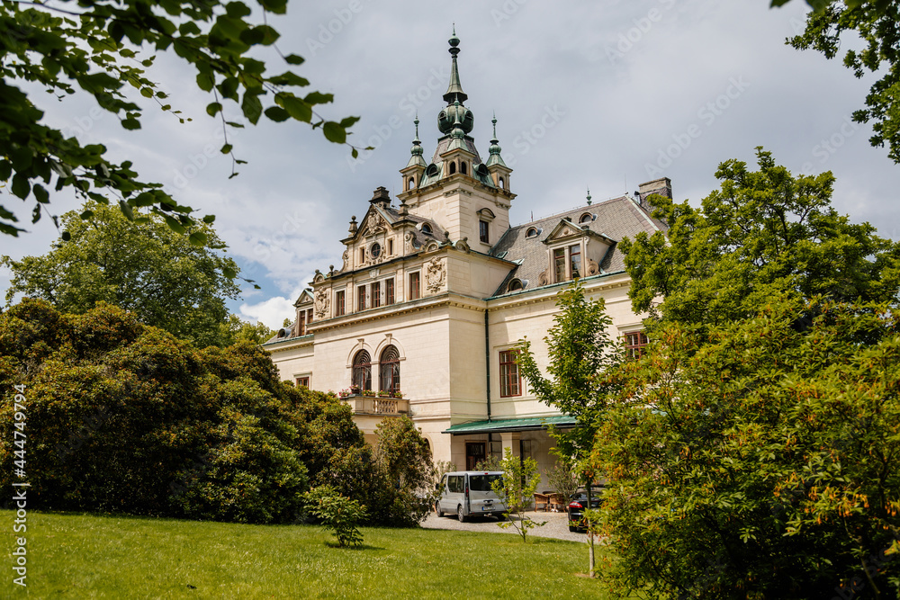Velke Brezno, Bohemia, Czech Republic, 26 June 2021:  State chateau with turret on the roof, Neo-Renaissance castle surrounded by a park at sunny summer day