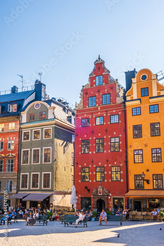 Stockholm Sweden - July 1 2021: Colourful historic buildings and houses in Gamla Stan, Main S. Romantic medieval city centre alleys. Popular tourist destination in Scandinavia on a sunny day.
