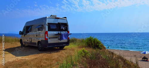 caravan car by the sea in summer beach trees blue sky