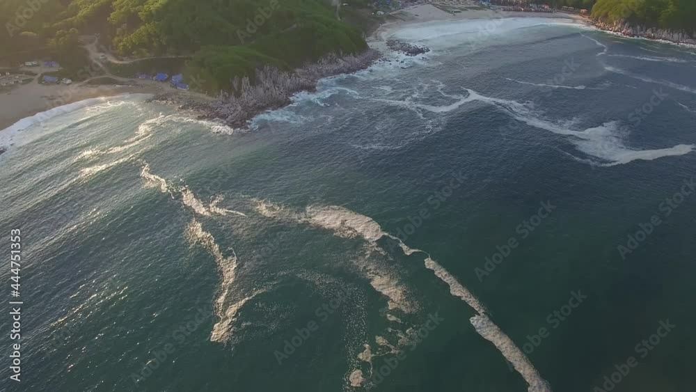 Aerial view of the beautiful sea coast with clear blue water at sunset Aerial view of the beautiful sea coast with clear blue water at sunset