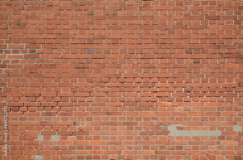 Red old brick wall with traces of mortar repair. Retro brickwall texture background