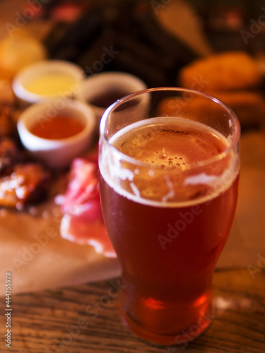 A glass of beer in the bar on a wooden table