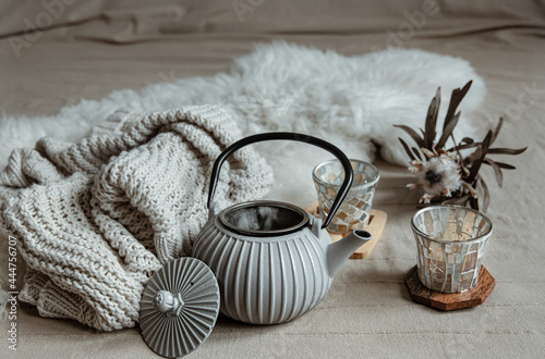 Cozy home composition with teapot and home decor details.