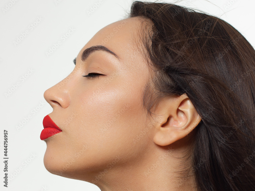 Closeup portrait of a woman with developing straight hair. Sweet tender young girl, brunette. Red lipstick on the lips, transparent transparent skin. Beauty, spa, injections, cosmetology, beautiful Closeup portrait of a woman with developing straight hair. Sweet tender young girl, brunette. Red lipstick on the lips, transparent transparent skin. Beauty, spa, injections, cosmetology, beautiful