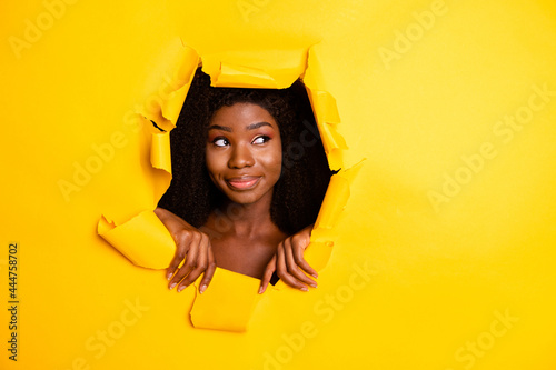 Photo of dreamy minded pensive lady look up empty space head hole through ripped yellow color background © deagreez