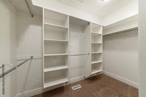 Interior of an empty walk-in closet room with floor vent