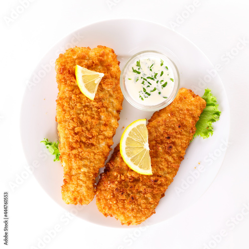 breaded fish with dipping sauce and lemon