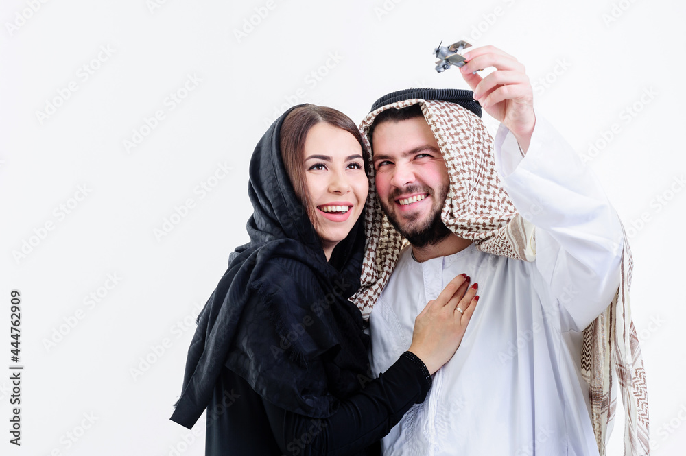 Middle eastern way dressed yang souple playing with toy plane Middle eastern way dressed yang souple playing with toy plane