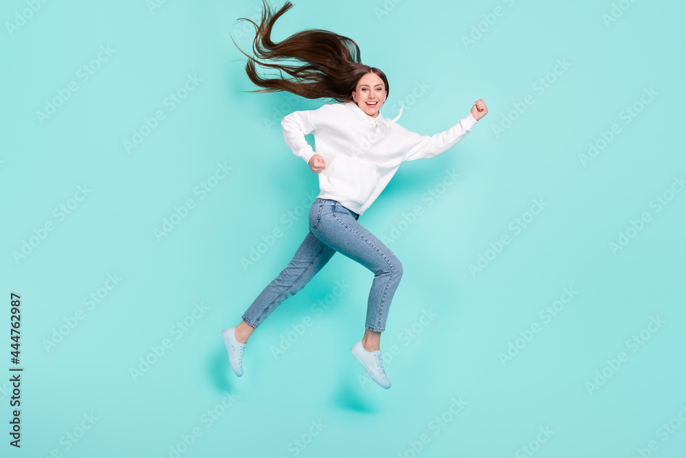 Full length body size view of pretty cheerful motivated girl jumping running isolated over bright teal turquoise color background