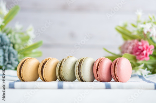 colorful macarons with flowers and white background