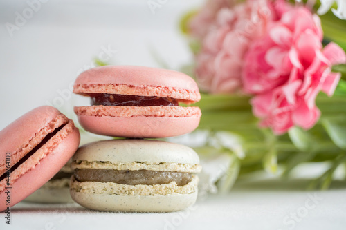 colorful macarons with flowers and white background