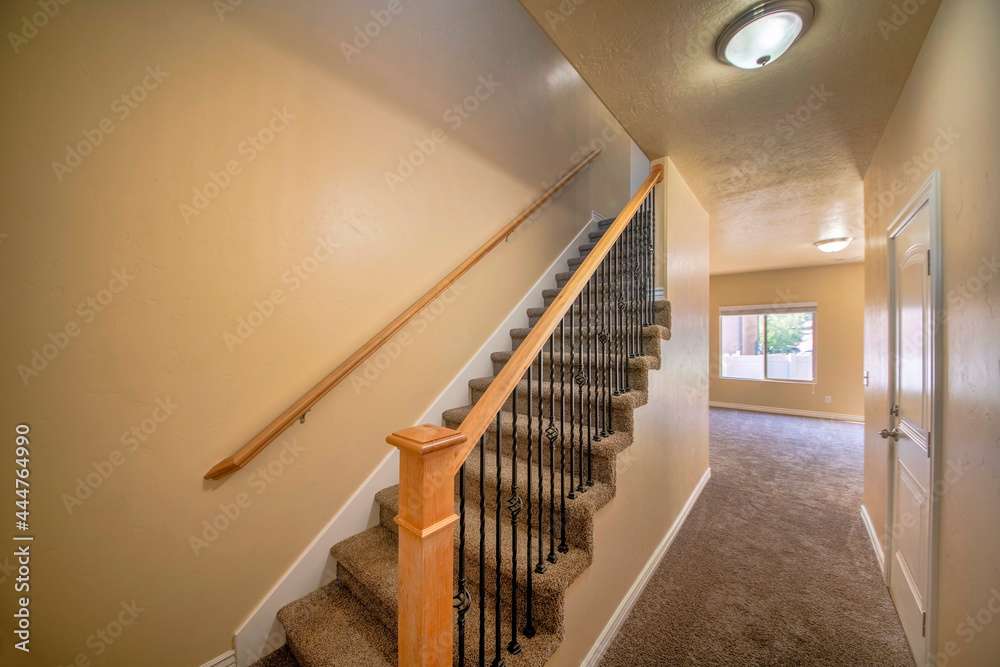 Interior of an empty house with stairs and carpeted flooring - obrazy, fototapety, plakaty 