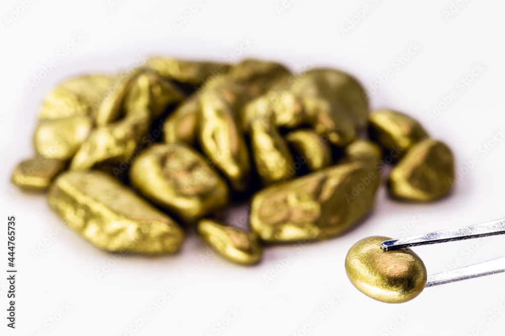 Royal gold nuggets heaped on isolated white background, rare stones mining concept.