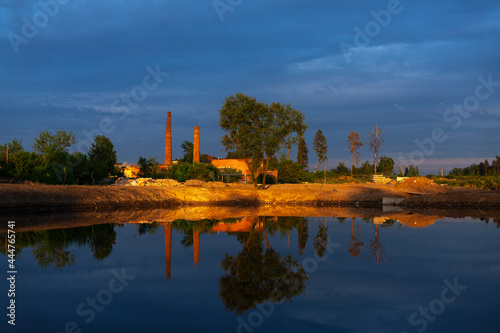 Pond at sunset. The sun is on the pond. An excavated pond in the city.