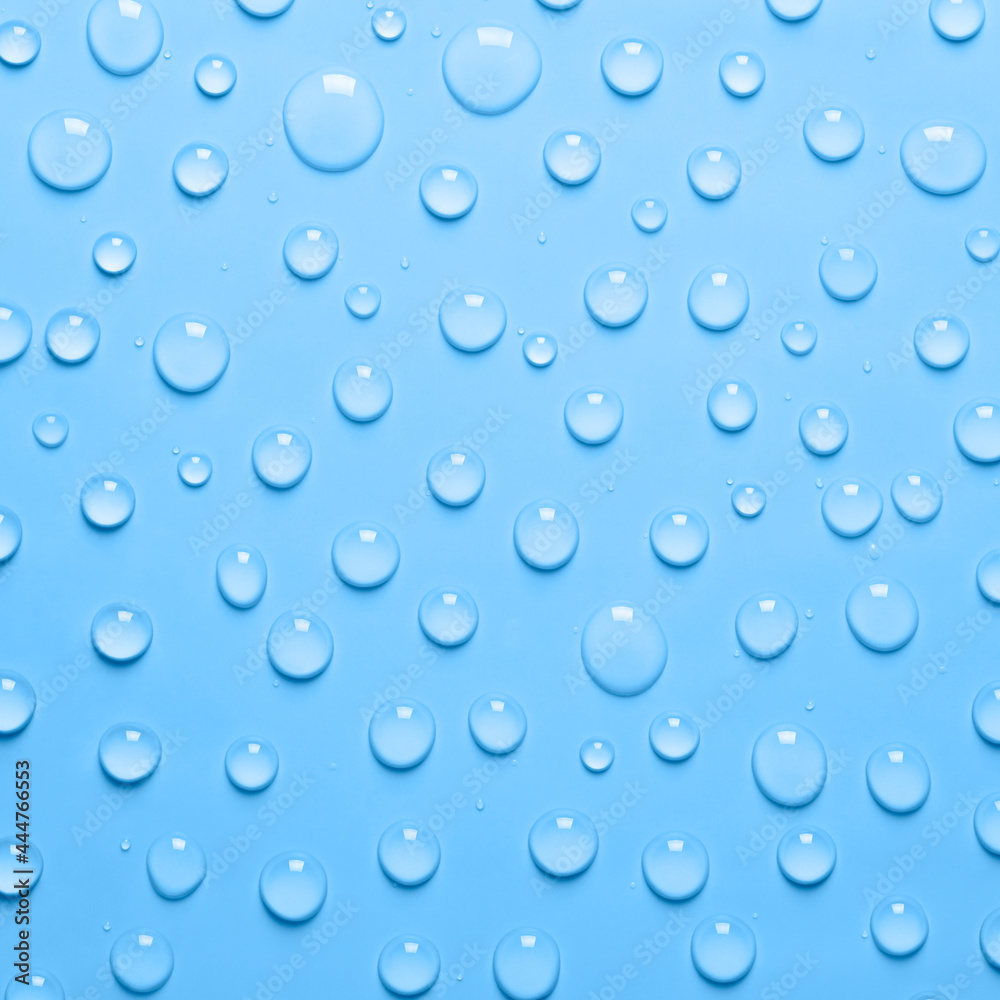 Water drops on blue background. Water texture close up. Backdrop glass covered with drops of water. Water bubbles.