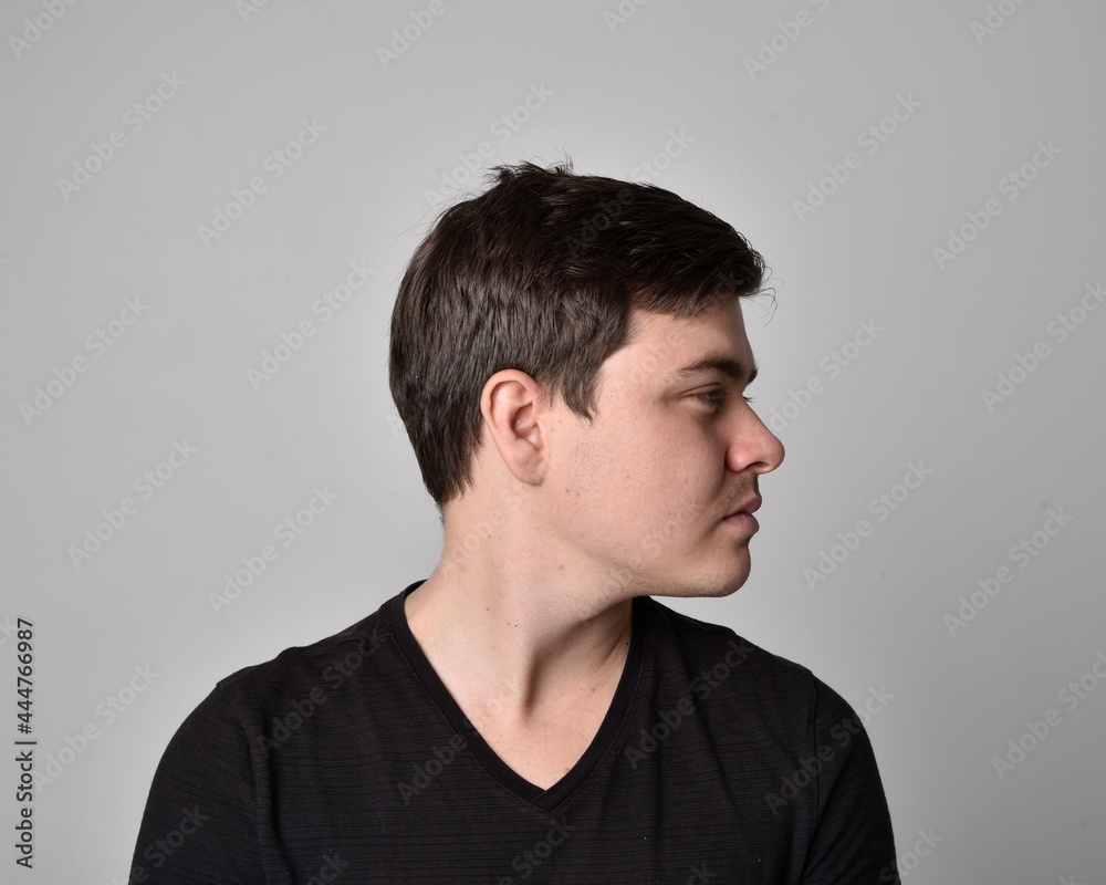 Obraz premium Close up head and shoulders portrait of a brunette. young man with a variety of expressive facial expressions. Isolated on a light grey studio background.