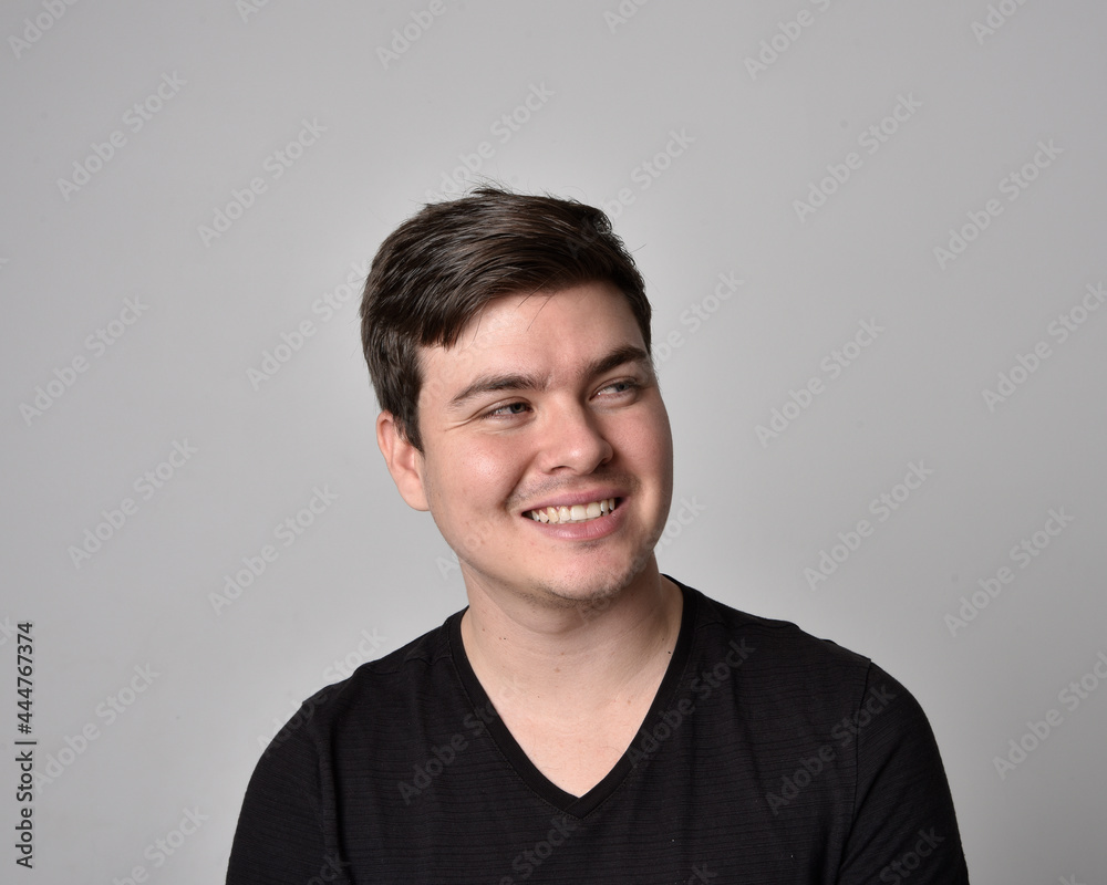 Close up head and shoulders portrait of a brunette. young man with a variety of expressive facial expressions. Isolated on a light grey studio background. Close up head and shoulders portrait of a brunette. young man with a variety of expressive facial expressions. Isolated on a light grey studio background.